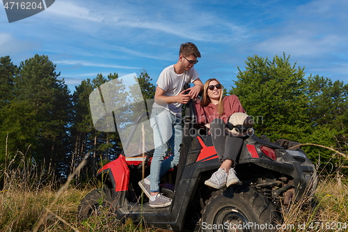 Image of couple enjoying beautiful sunny day while driving a off road buggy