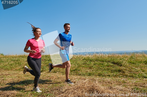 Image of couple jogging in a healthy lifestyle on a fresh mountain air