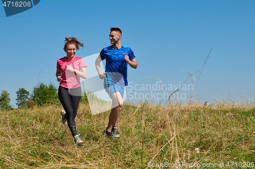 Image of couple jogging in a healthy lifestyle on a fresh mountain air