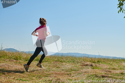 Image of woman enjoying in a healthy lifestyle while jogging