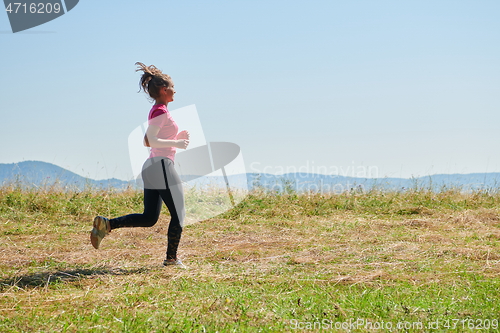 Image of woman enjoying in a healthy lifestyle while jogging