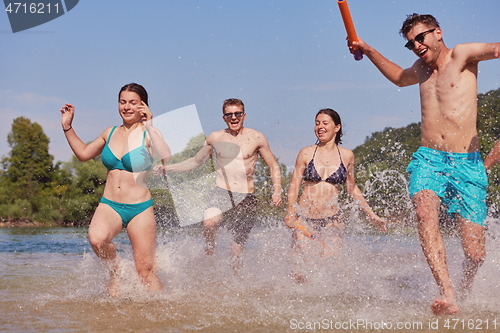 Image of group of happy friends having fun on river