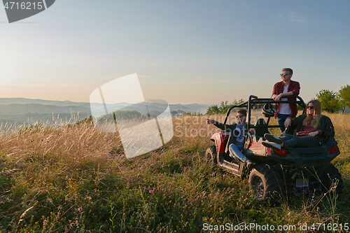 Image of group young happy people enjoying beautiful sunny day while driving a off road buggy car