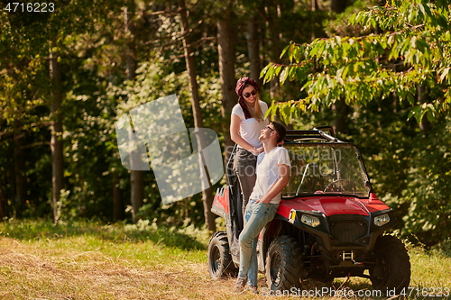 Image of couple enjoying beautiful sunny day while driving a off road buggy