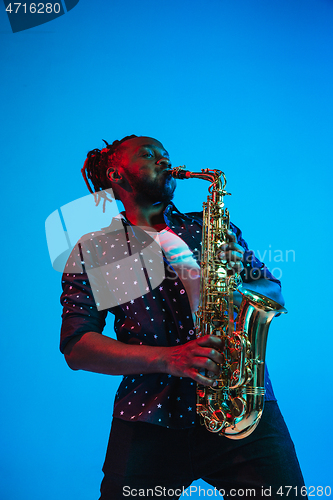 Image of Young african-american jazz musician playing the saxophone