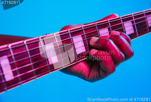 Image of Young african-american jazz musician playing the guitar