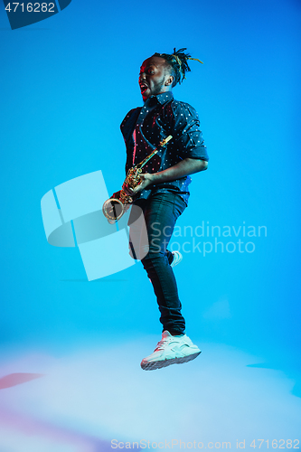 Image of Young african-american jazz musician playing the saxophone