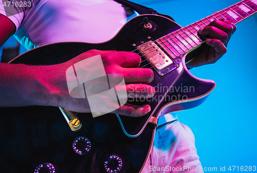 Image of Young african-american jazz musician playing the guitar