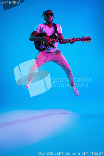 Image of Young african-american jazz musician playing the guitar