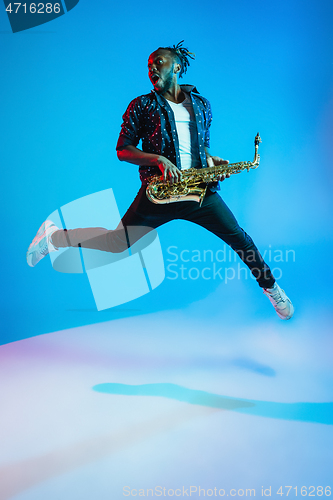 Image of Young african-american jazz musician playing the saxophone