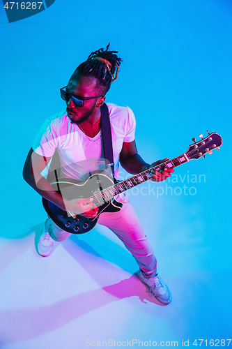 Image of Young african-american jazz musician playing the guitar