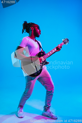 Image of Young african-american jazz musician playing the guitar