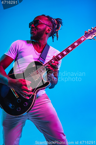 Image of Young african-american jazz musician playing the guitar