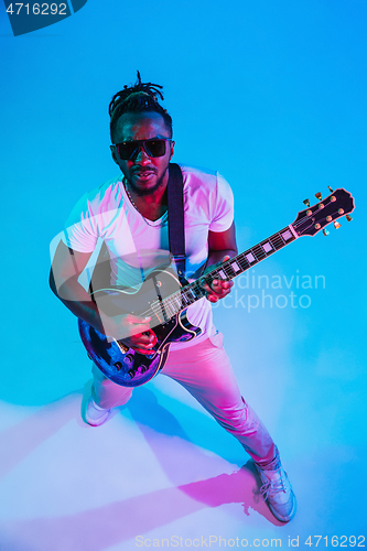 Image of Young african-american jazz musician playing the guitar