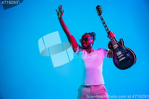 Image of Young african-american jazz musician playing the guitar