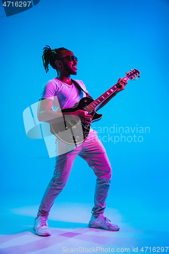 Image of Young african-american jazz musician playing the guitar