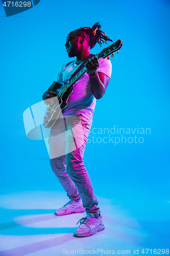 Image of Young african-american jazz musician playing the guitar