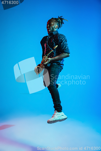 Image of Young african-american jazz musician playing the saxophone