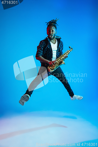 Image of Young african-american jazz musician playing the saxophone