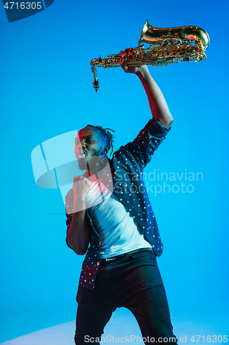 Image of Young african-american jazz musician playing the saxophone