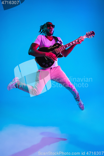 Image of Young african-american jazz musician playing the guitar