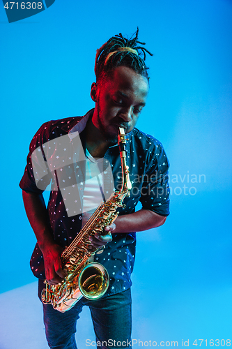 Image of Young african-american jazz musician playing the saxophone