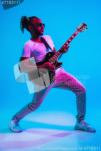 Image of Young african-american jazz musician playing the guitar