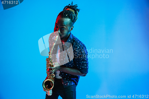 Image of Young african-american jazz musician playing the saxophone