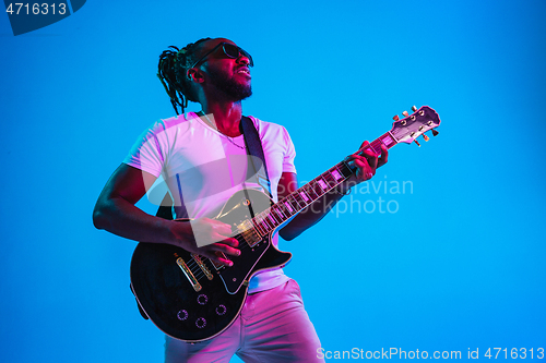 Image of Young african-american jazz musician playing the guitar