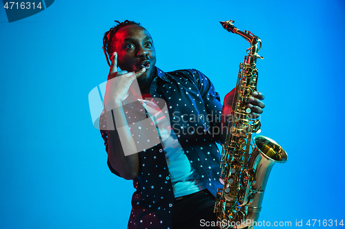 Image of Young african-american jazz musician playing the saxophone