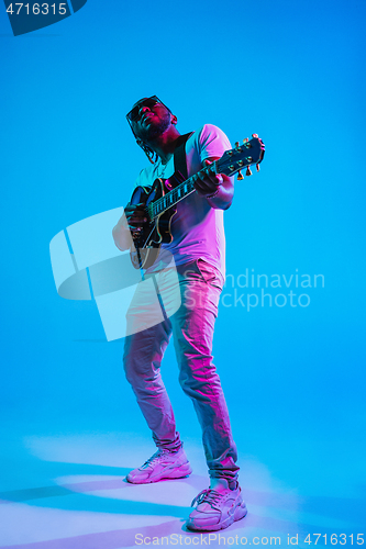 Image of Young african-american jazz musician playing the guitar