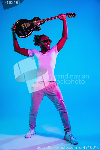 Image of Young african-american jazz musician playing the guitar