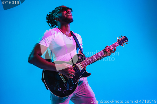 Image of Young african-american jazz musician playing the guitar