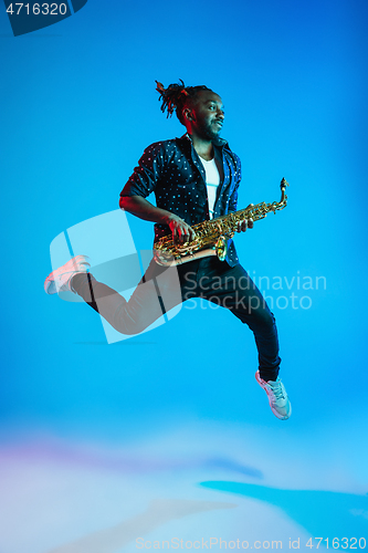 Image of Young african-american jazz musician playing the saxophone