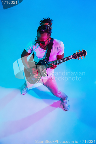 Image of Young african-american jazz musician playing the guitar