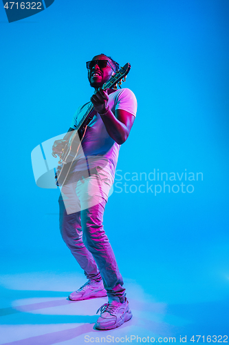 Image of Young african-american jazz musician playing the guitar