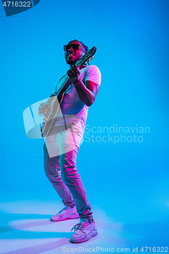 Image of Young african-american jazz musician playing the guitar