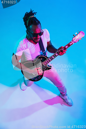 Image of Young african-american jazz musician playing the guitar