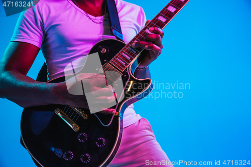 Image of Young african-american jazz musician playing the guitar