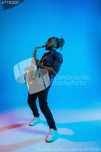 Image of Young african-american jazz musician playing the saxophone