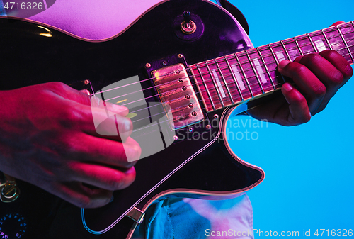 Image of Young african-american jazz musician playing the guitar