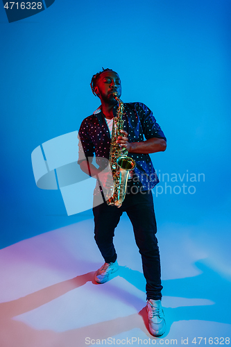 Image of Young african-american jazz musician playing the saxophone