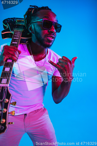 Image of Young african-american jazz musician playing the guitar