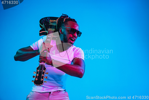 Image of Young african-american jazz musician playing the guitar