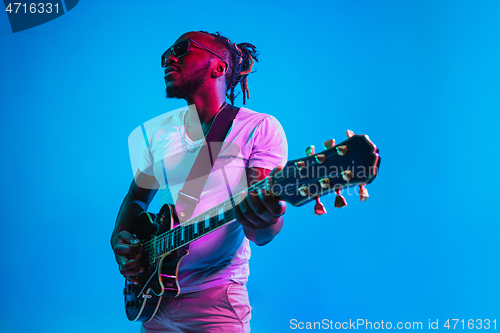 Image of Young african-american jazz musician playing the guitar