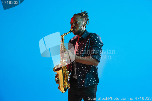 Image of Young african-american jazz musician playing the saxophone