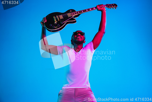 Image of Young african-american jazz musician playing the guitar