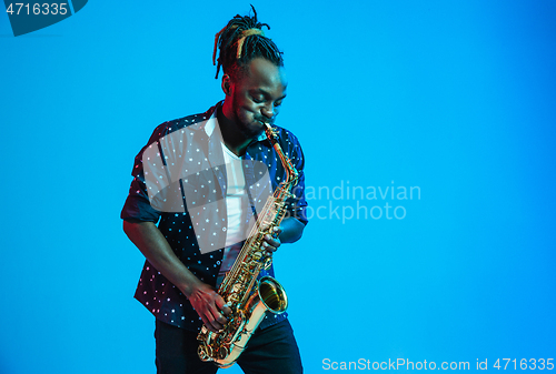 Image of Young african-american jazz musician playing the saxophone