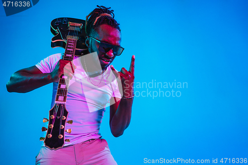 Image of Young african-american jazz musician playing the guitar