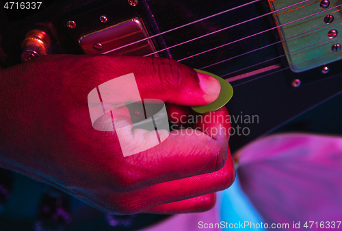 Image of Young african-american jazz musician playing the guitar